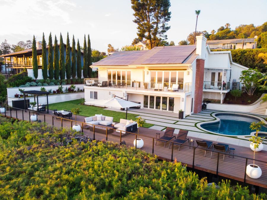Landscaped backyard with patio and pool by Southcal Landscape